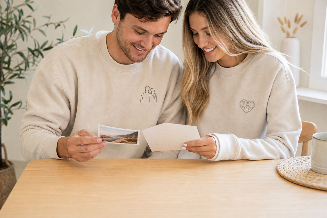 Couple wearing personalized sweatshirts beside a shared memory photo.