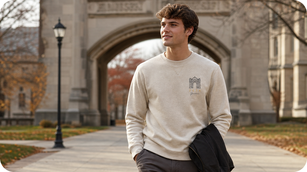 Graduate wearing a personalized college graduation keepsake with a campus arch and handwriting on the left chest