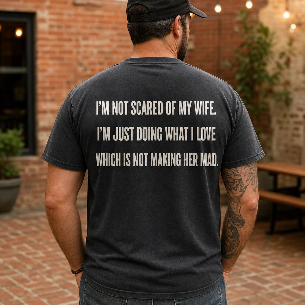 Custom Wife Photo Embroidered T-Shirt with Funny Back Print - Husband Gift back worn product image with custom printed phrase with custom left chest embroidery based on clear candid couple photo with a married couple