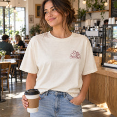 Custom Couple Coffee Date Outline Embroidered T-Shirt with Back Print - Anniversary Gift front worn product image with left chest embroidery with custom left chest embroidery based on candid couple sharing coffee at a small cafe table