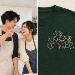 Custom Couple Kitchen Date Outline Embroidered T-Shirt with Back Print - Funny Couple Gift source photo and front embroidery product image with custom left chest embroidery based on candid couple cooking together in a bright home kitchen