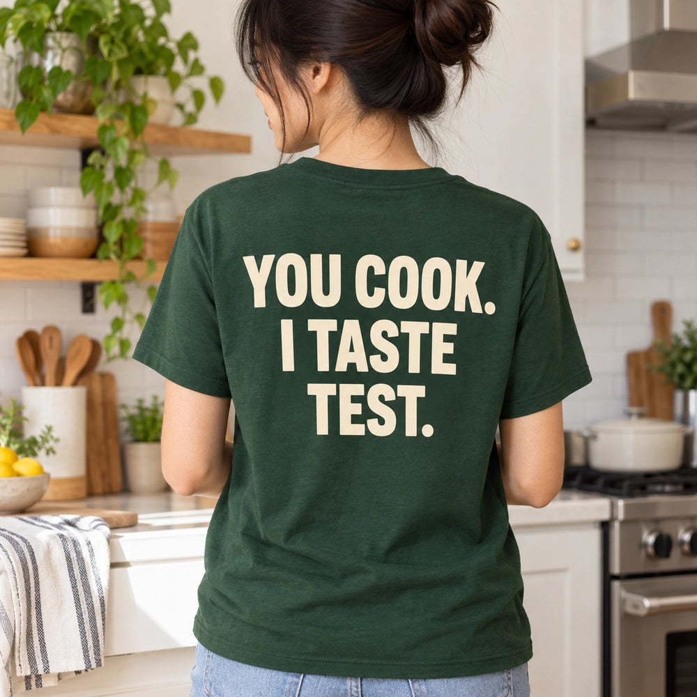Custom Couple Kitchen Date Outline Embroidered T-Shirt with Back Print - Funny Couple Gift back worn product image with custom printed phrase with custom left chest embroidery based on candid couple cooking together in a bright home kitchen