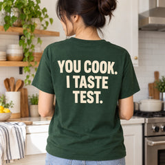 Custom Couple Kitchen Date Outline Embroidered T-Shirt with Back Print - Funny Couple Gift back worn product image with custom printed phrase with custom left chest embroidery based on candid couple cooking together in a bright home kitchen