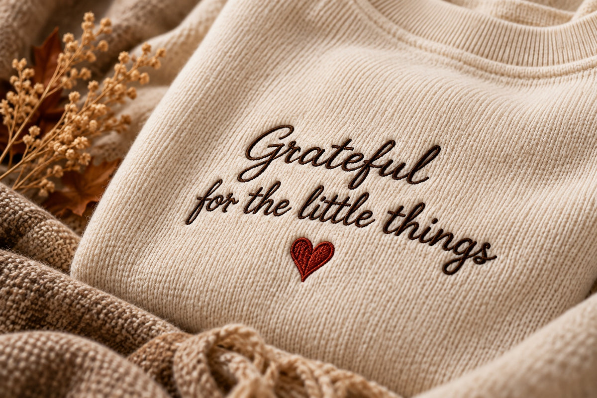 Cream embroidered sweatshirt reading Grateful for the little things